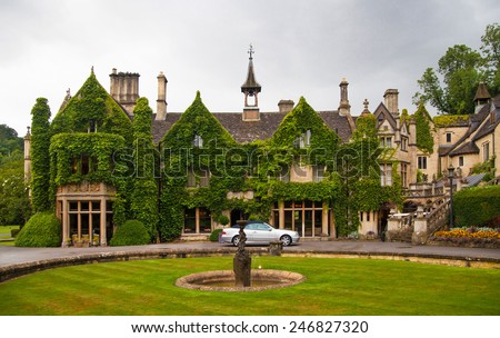 CHIPPENHAM, UK - AUGUST 9, 2014: Castle Combe park and old house. Mansion of very reach people 19th century