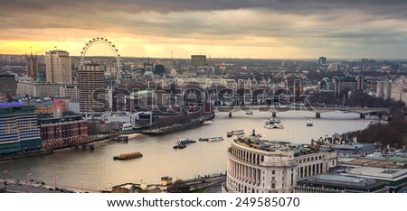 LONDON, UK - JANUARY 27, 2015: London eye, river Thames and London\'s bridges in sunset. Panoramic view form st. Paul cathedral