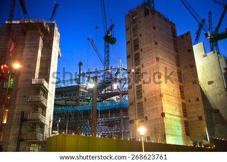 LONDON, UK - DECEMBER 19, 2014: Building site with cranes in the City of London business. New development next to bank of England. Night view