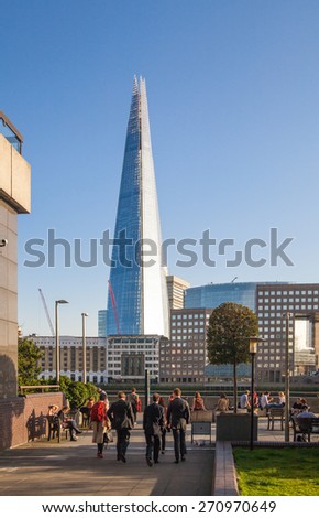 LONDON, UK - APRIL15, 2015: Shard of glass in sunset. Panoramic view of south bank river Thames walk.
