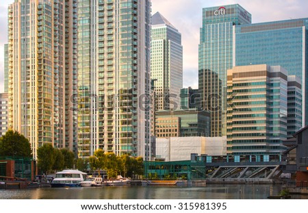 LONDON, UK - 7 SEPTEMBER, 2015: Canary Wharf skyscrapers at sunset reflection. Evening life of Business district