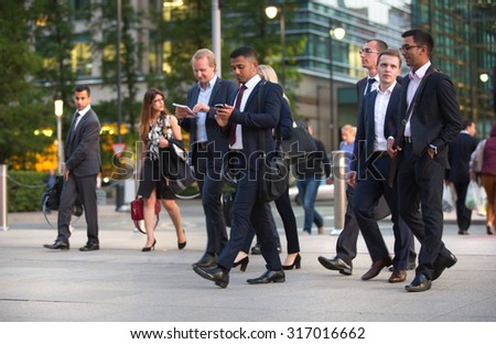 LONDON, UK - 7 SEPTEMBER, 2015: Canary Wharf business life. Group of business people going home after working day.