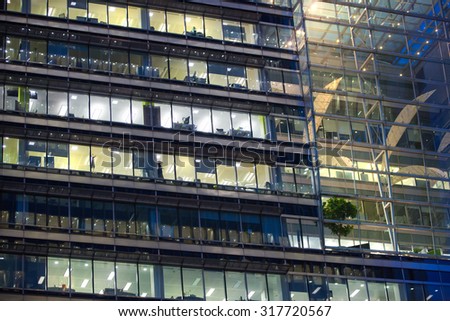 LONDON, UK - 7 SEPTEMBER, 2015: Canary Wharf office\'s windows lit up in the night.