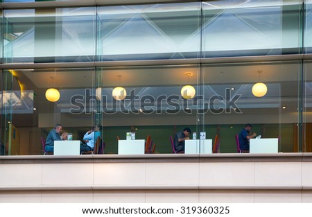 LONDON, UK - MAY 5, 2015: Canary Wharf banking and business centre, cafe. Office workers having lunch