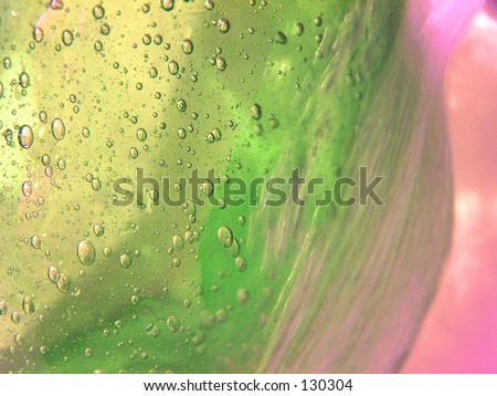 green glass vase with bubbles under running water