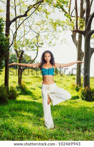 Beautiful Woman Practicing Yoga Outside in Nature