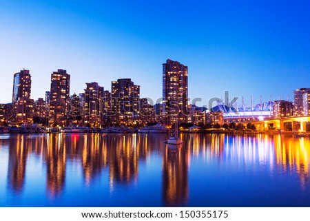 Modern Urban City Skyline Reflecting in Water at Sunset, Vancouver