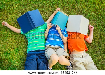 Happy Kids, Group of Young Boys Reading Books Outside Together after School