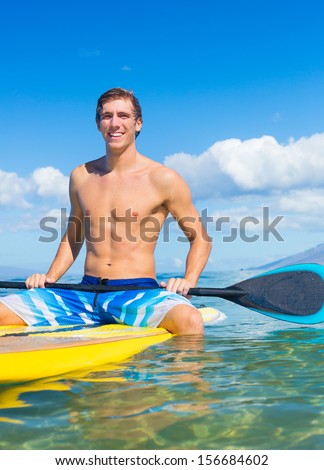 Attractive Young Man Stand Up Paddle Surfing In Hawaii, Beautiful Tropical Ocean, Active Beach Lifestyle