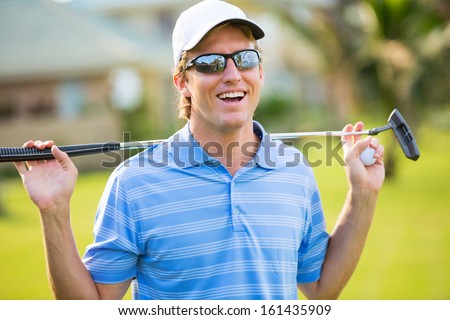 Athletic young man playing golf, Portrait of Golfer on Course with putter