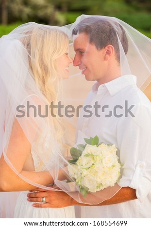 Just married couple kissing on tropical beach, Hawaii Beach Wedding