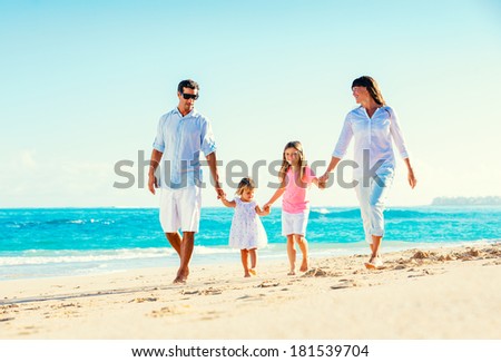 Happy Family Having Fun Walking on Tropical Beach
