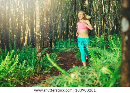 Woman Running in Nature. Trail Running in Forest. Active Healthy Lifestyle Fitness Concept.