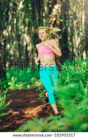 Woman Running in Nature. Trail Running in Forest. Active Healthy Lifestyle Fitness Concept.