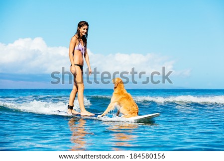 Attractive Young Woman Surfing with her Dog. Riding Wave Together in Ocean. Surfing Dog.