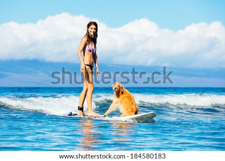 Attractive Young Woman Surfing with her Dog. Riding Wave Together in Ocean. Surfing Dog.