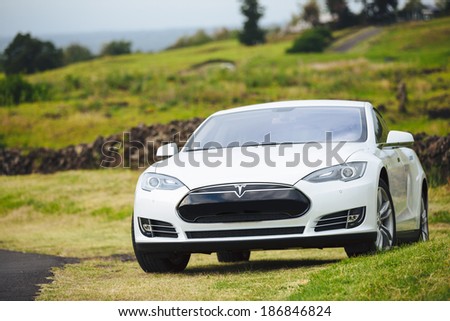 San Francisco, CA - April 2014: Tesla Motors model S sedan electric car on country road, Tesla\'s new Gigafactory would help Tesla increase its monthly production volume to 20,000 cars per month.