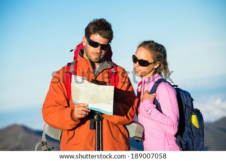 Hikers looking at trail map. Hiking in the mountains.