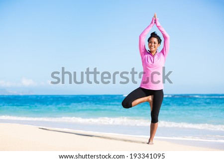 Beautiful young woman in yoga pose at the beach. Morning zen mediation outdoors. Practicing yoga. Healthy Active Lifestyle Concept.