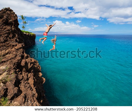 Summer fun, Friends cliff jumping into the ocean.