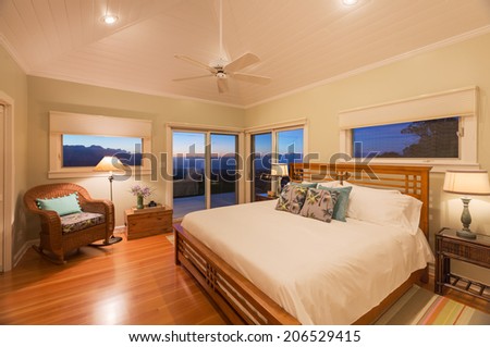 Cozy spacious bedroom in beautiful home at sunset