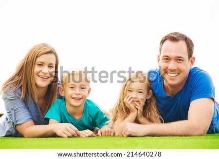 Portrait of Happy Family Outside on Grass