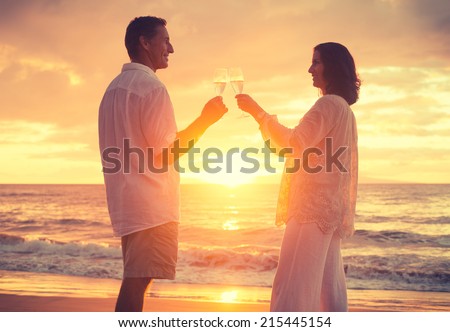Romantic Retired Couple Drinking Champagne to Celebrate on Vacation