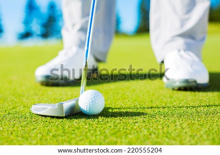 Man Putting Golf Ball into the Hole, Close up detail Shot