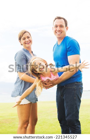 Portrait of Happy Family Outside Playing