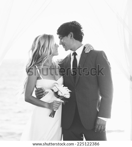 Wedding, Beautiful Romantic Bride and Groom Kissing and Embracing at Sunset. Black and White Image.