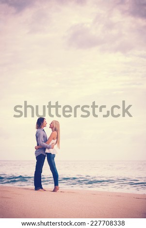 Romantic Couple in Love on the Beach at Sunset, Beautiful Sunset Clouds Copyspace with Room for Text