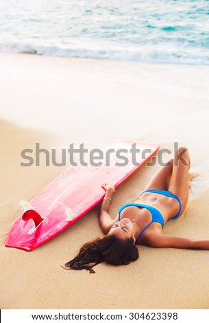 Beautiful Surfer Girl Relaxing on the Beach. Summer Outdoor Lifestyle.