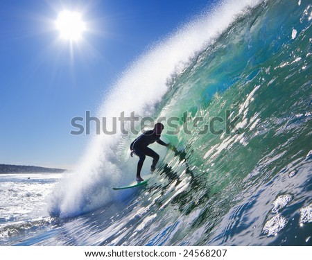Backlit Surfer on Big Wave in the Tube on a Sunny Blue Sky Day
