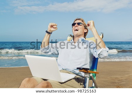 Young Attractive Man Celebrating Success, Working on Computer at the Beach