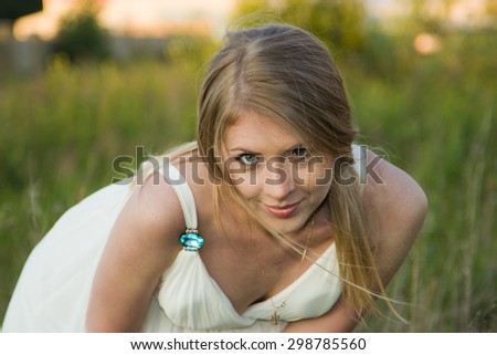 One of the photos Made during a photo shoot of Russian girl in summer at sunset.The girl in a role of the bride.