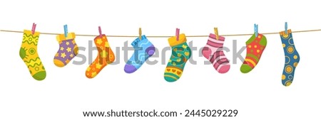 Cotton and wool socks on clothesline. Socks hanging on a rope with clothespins, vector cute baby laundry. Cartoon foot clothes with color hearts, stars, stripes and flowers pattern drying on string