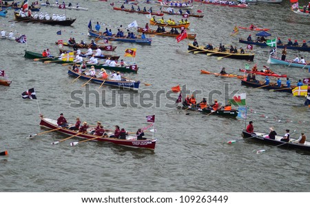 LONDON - JUNE 3: Unidentified boats sail down the River Thames during Diamond Jubilee Pageant celebration to mark the Queens Diamond Jubilee in London, England on June 3, 2012.