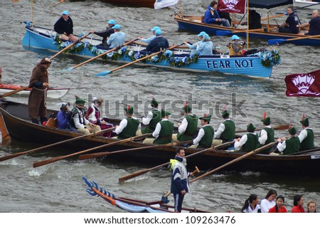 LONDON - JUNE 3: Unidentified boats sail down the River Thames during Diamond Jubilee Pageant celebration to mark the Queens Diamond Jubilee in London, England on June 3, 2012.