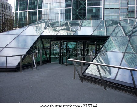 This entrance to jubilee place  London\'s docklands, if you look in the reflection you can see Canary wharf.
