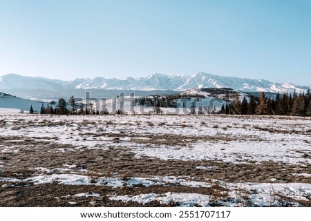 Similar – Image, Stock Photo The onset of winter in summery Lech am Arlberg. Lonely mountain farm, mountain pasture, mountain forest and the snow-covered Karhorn.