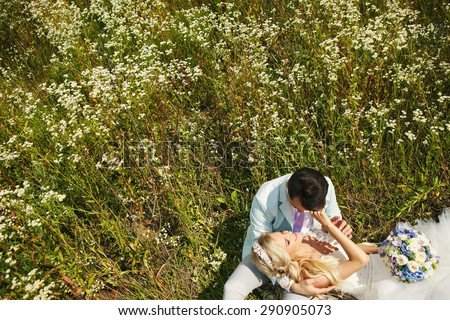 Very beautiful bride and groom in a field where many colors and beautiful nature
