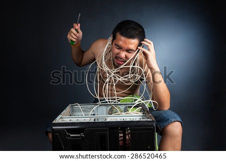 man having his computer phoning technical support for help