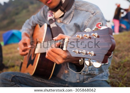 Acoustic Guitar Playing. Men Playing Acoustic Guitar Closeup Photography.