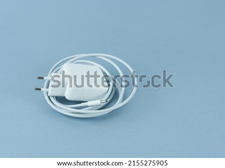 A charger for a tablet on a blue background. Phone charger. Photo stock © 