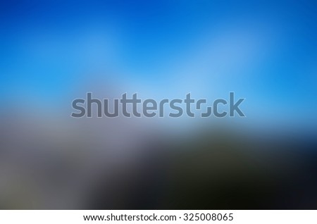 blurry natural and blue sky background. Horizontal composition defocused image space for text. Blue gray green and white colors.