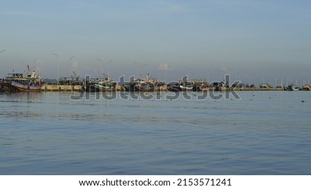 traditional fishing boat leaning on the pier in the morning with calm sea, Indonesia, Jepara, kapal nelayan, kapal ikan, dermaga, pantai, laut Stok fotoğraf © 