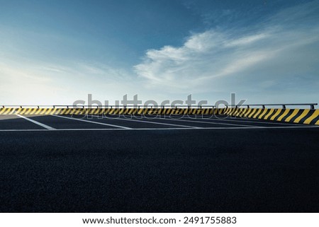 Similar – Image, Stock Photo Empty parking lot. A sign ‘Lehrerparkplatz’ in front of a school building with closed shutters