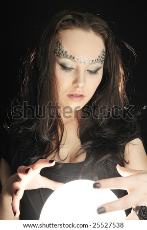 Young witch make wishing with a Magic crystal ball