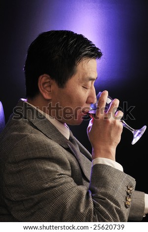Asia businessman Drinking red wine