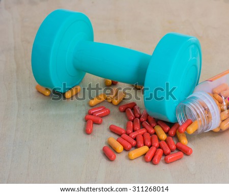 dumbbell with capsule, Dieting by medicine lose weight, Dieting concept
